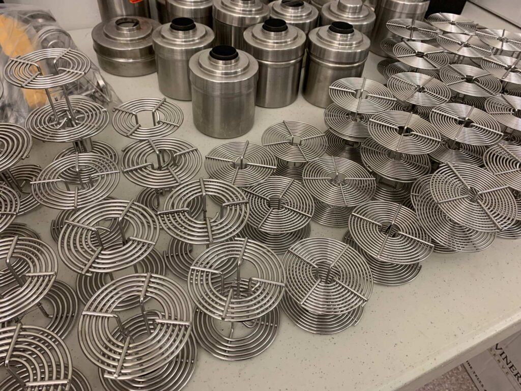 Stainless steel developing tanks and reels on a counter